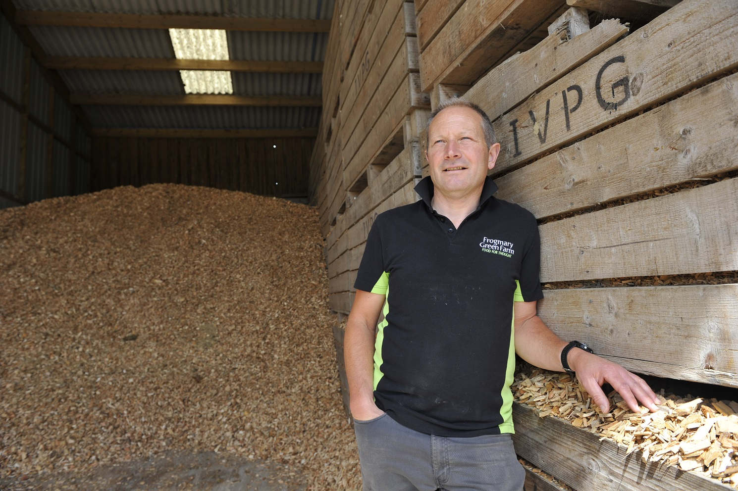 Person stood in front of chicken feed storage