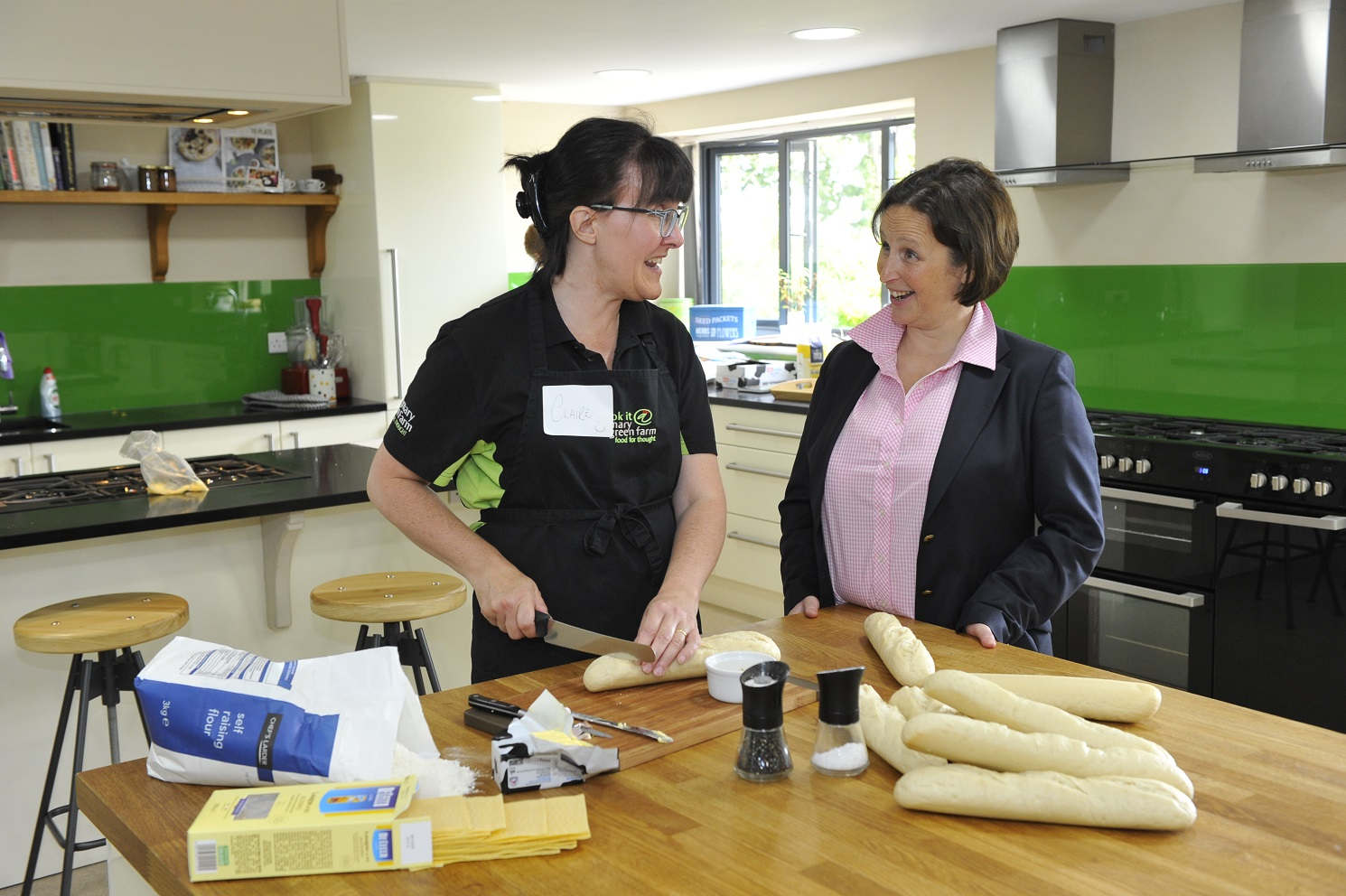Two people talk in the cookery school